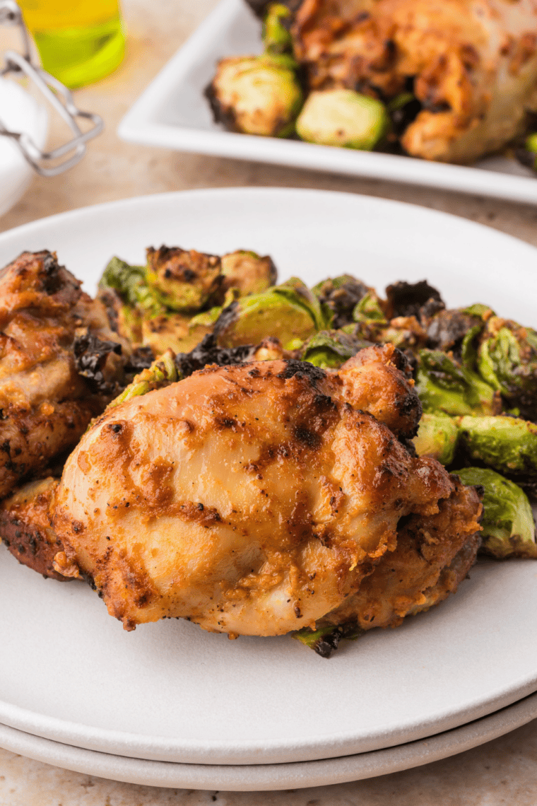 Plate of air fryer balsamic glazed chicken thighs with a glossy, sticky balsamic glaze