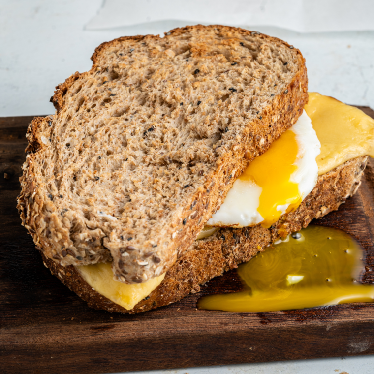 Air Fryer Breakfast Grilled Cheese with melted provolone, fried egg, and golden crispy bread, ready to serve.