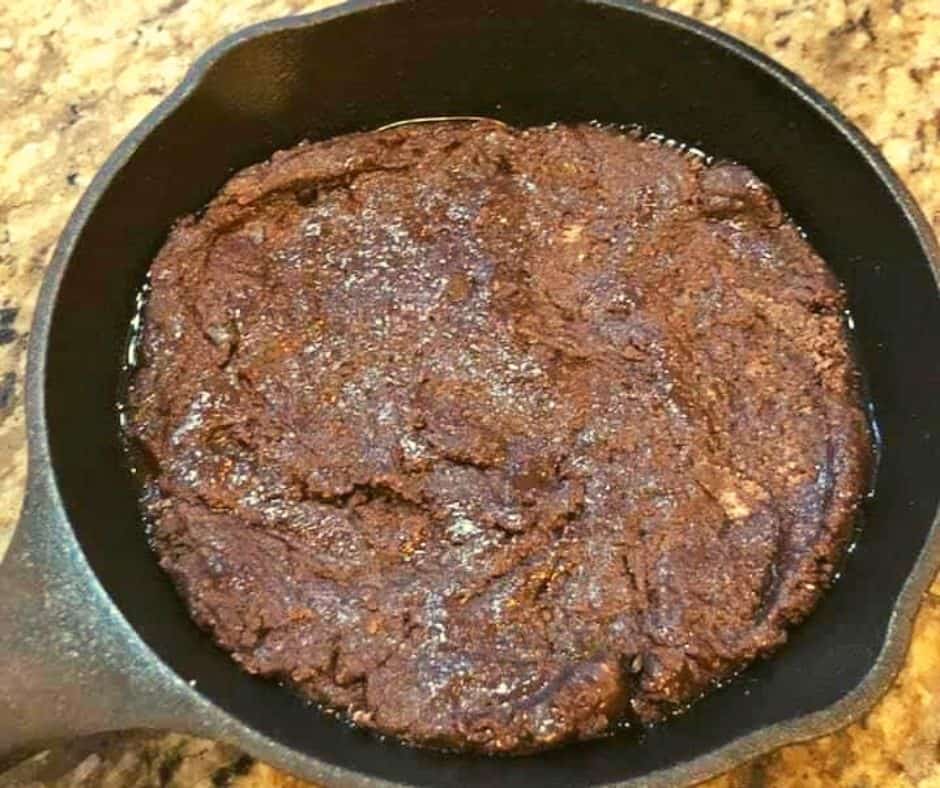 Placing the skillet with brownie batter into the air fryer basket