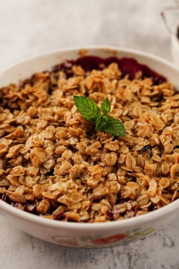 Close-up of cherry crisp in air fryer dish with crispy oat crumble and red cherry filling