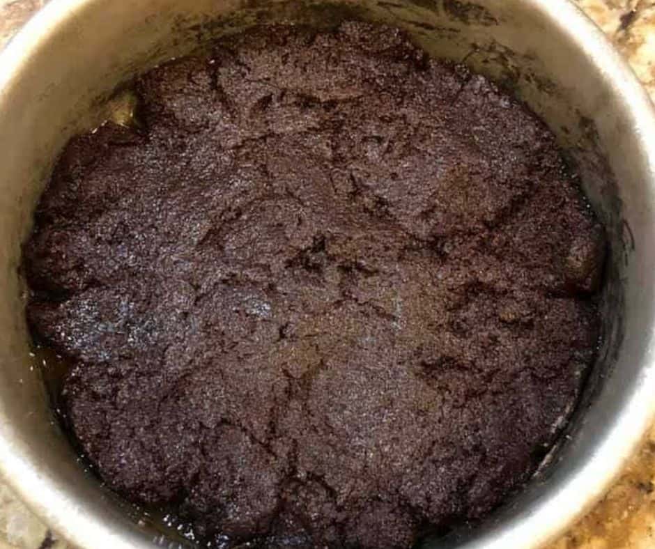 Pouring brownie batter into a greased baking dish for Air Fryer Brownie Chocolate Pudding