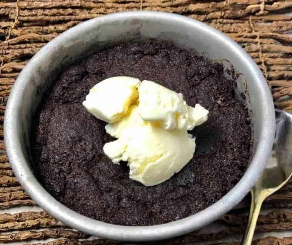 Serving Air Fryer Brownie Chocolate Pudding with a spoon and garnished with toppings