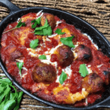Air fryer meatball bubble up bake with melted mozzarella and marinara in a round pan