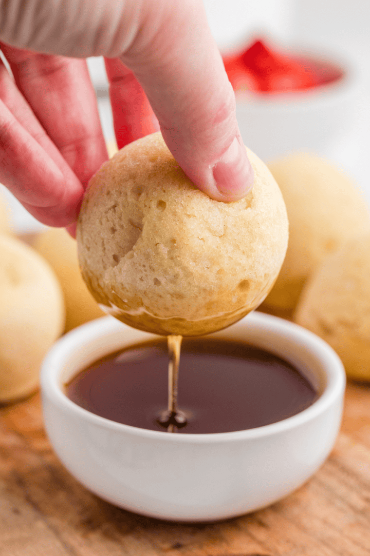 Bite-sized golden pancake bites made in the air fryer, served with syrup and fresh berries.