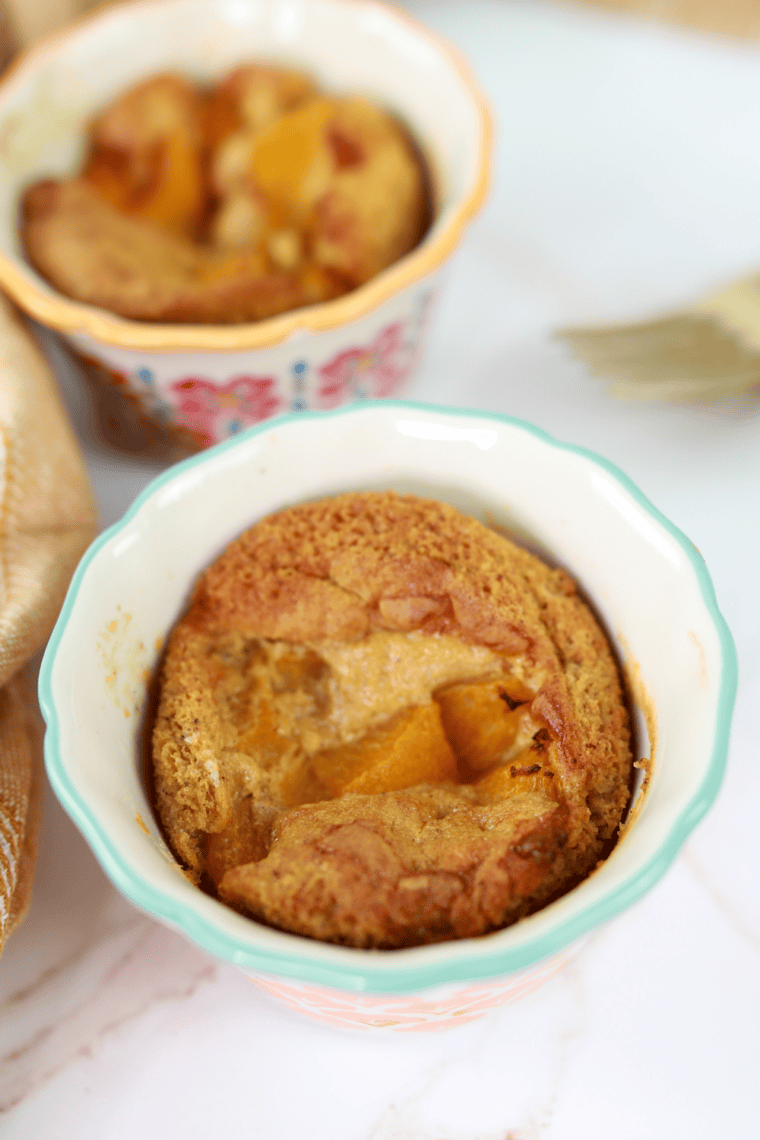 Air fryer gluten-free peach cobbler with bubbling peaches and crisp golden topping