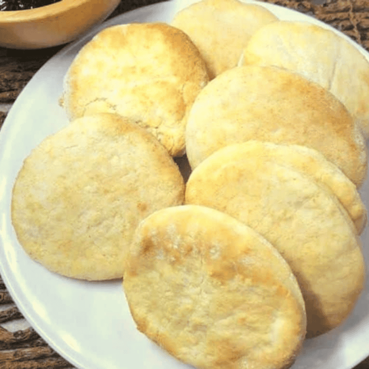 Golden, flaky Bisquick biscuits freshly cooked in the air fryer and ready to serve.