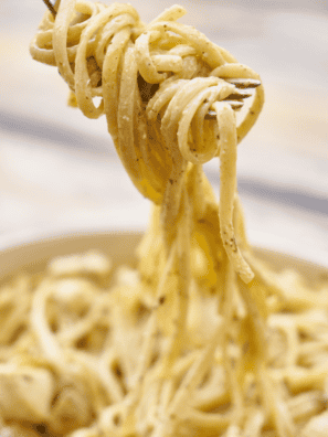 Bowl of Instant Pot Parmesan Pasta Roni Copycat with creamy cheese sauce and grated Parmesan on top