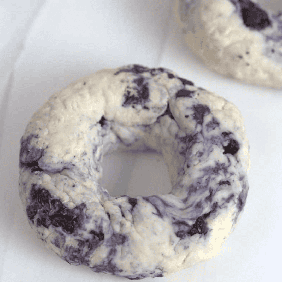 Shaping dough into bagels on a floured surface