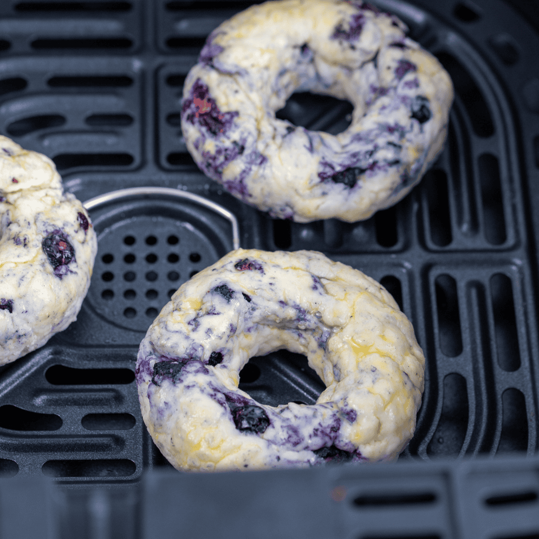 Air frying blueberry bagels until golden brown