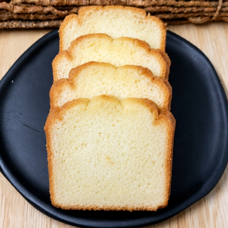 Slices of 4 ingredient air fryer pound cake served on a black plate