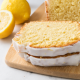 Sliced air fryer lemon loaf with white glaze showing the tender crumb