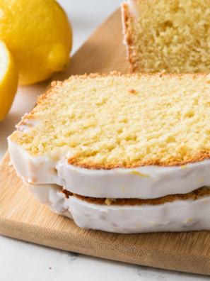 Sliced air fryer lemon loaf with white glaze showing the tender crumb