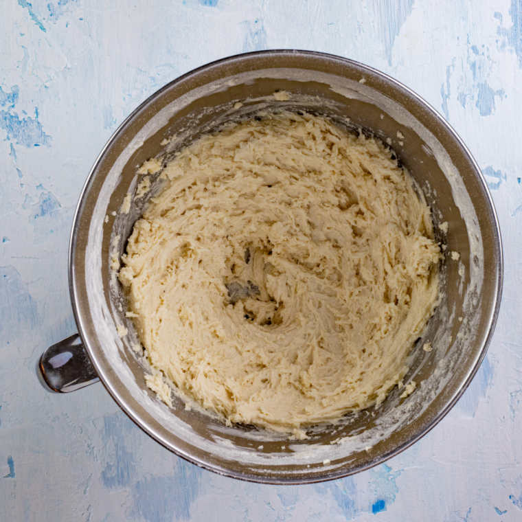 Folding dry ingredients into lemon loaf batter with a rubber spatula
