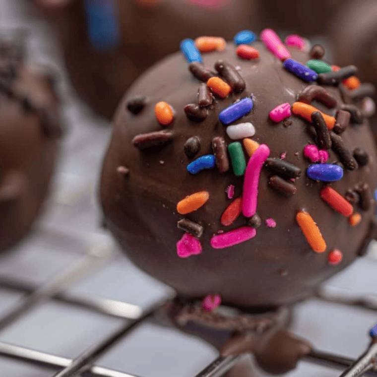 Air Fryer chocolate donut holes cooking to a golden, crispy perfection.

