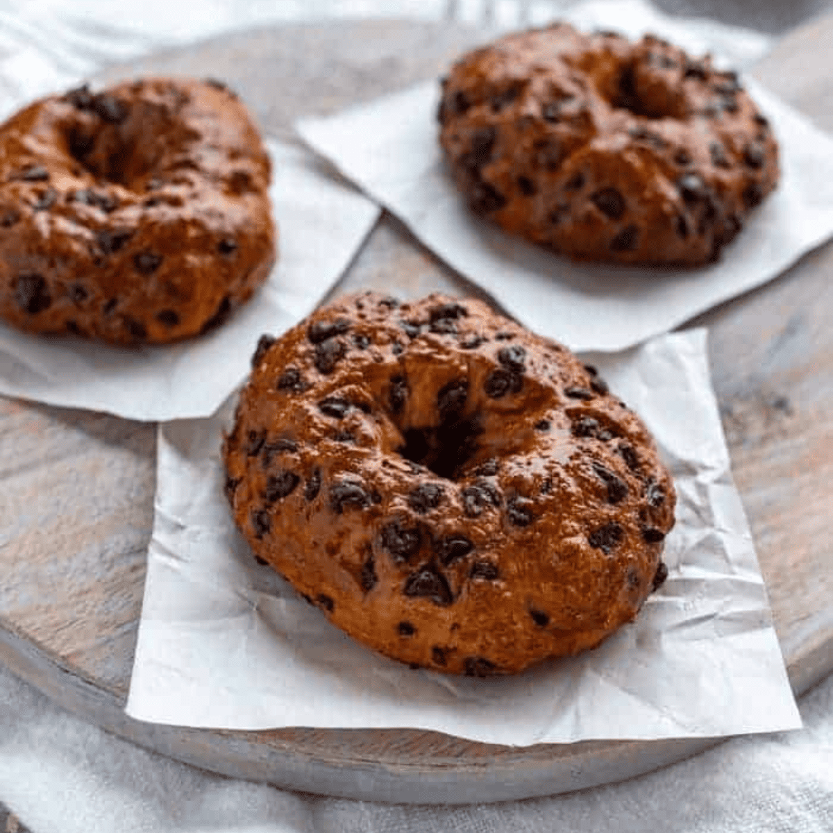 Air Fryer chocolate chip bagels in the air fryer basket, showing their even cooking and crisp texture.