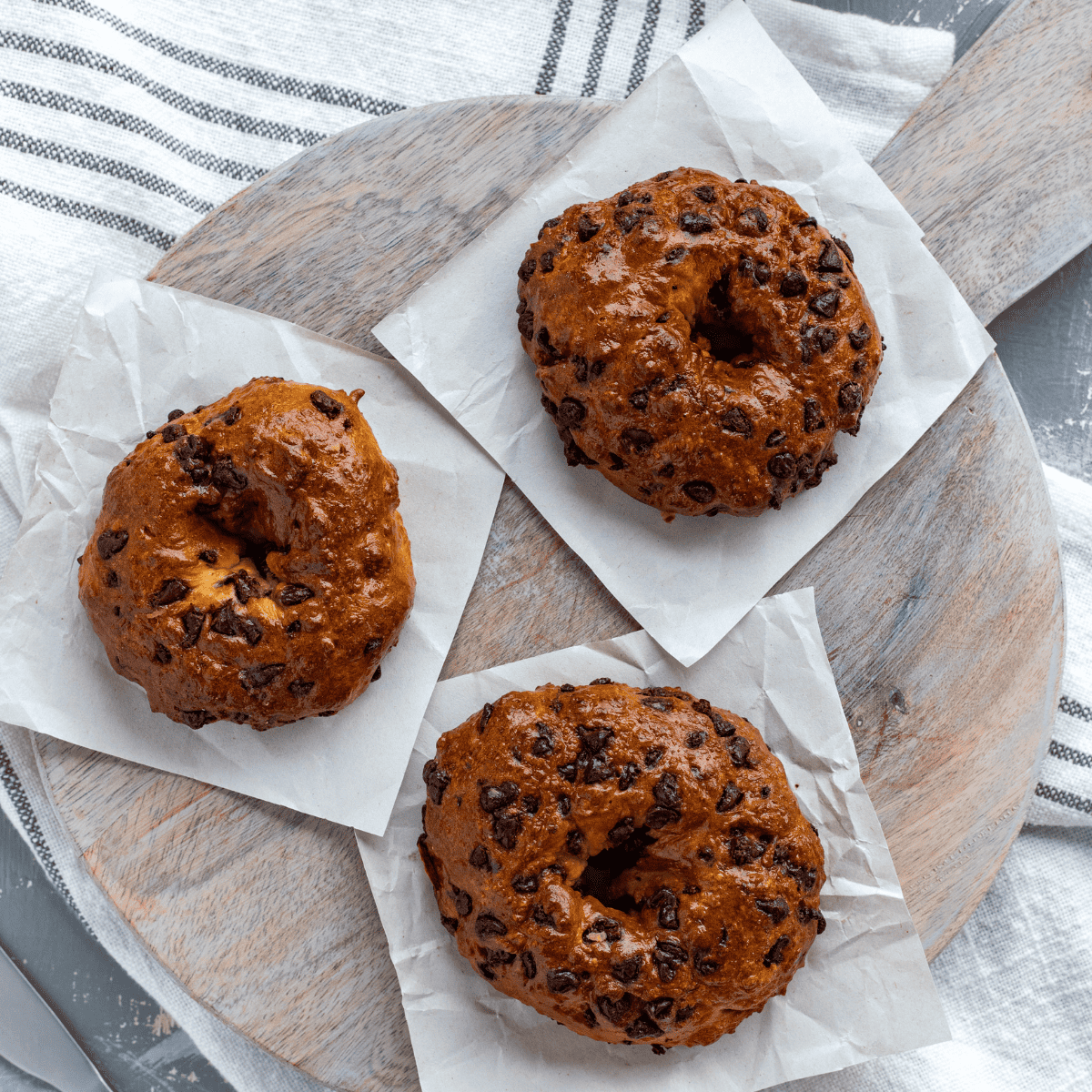 Air Fryer chocolate chip bagels served on a plate, showcasing their light, fluffy interior and chocolatey goodness.