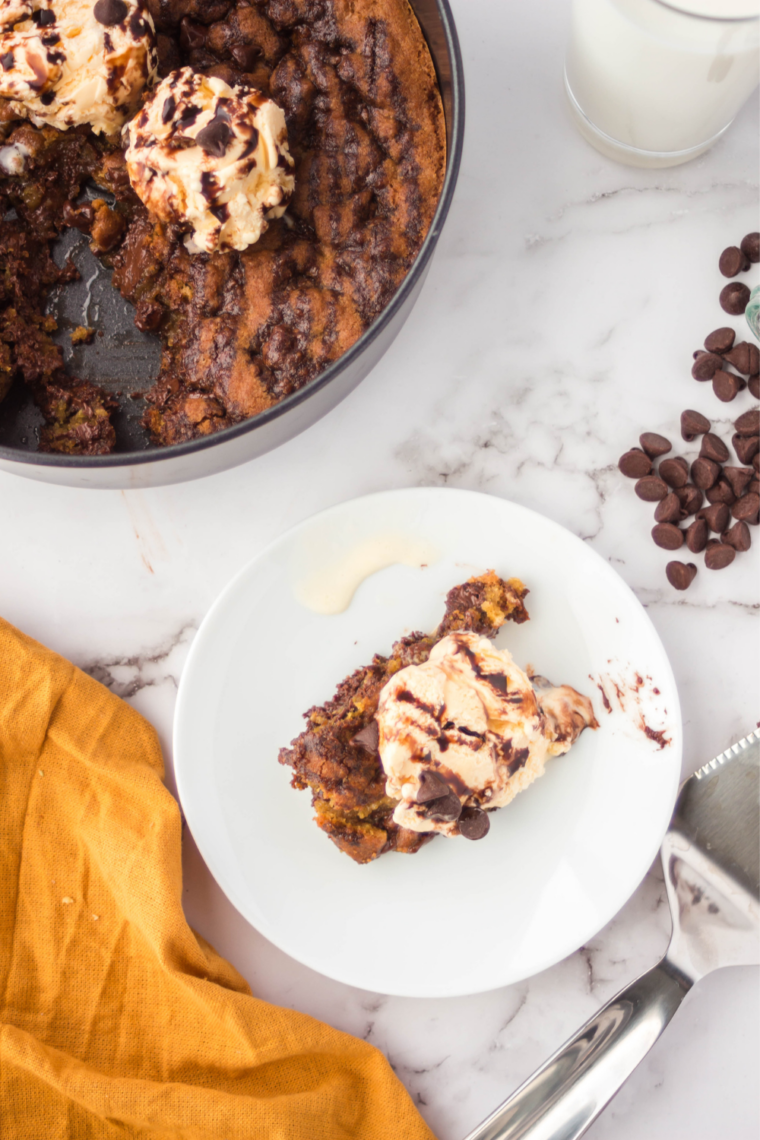 Air fryer chocolate chip cookie pizza sliced into wedges on a wooden board