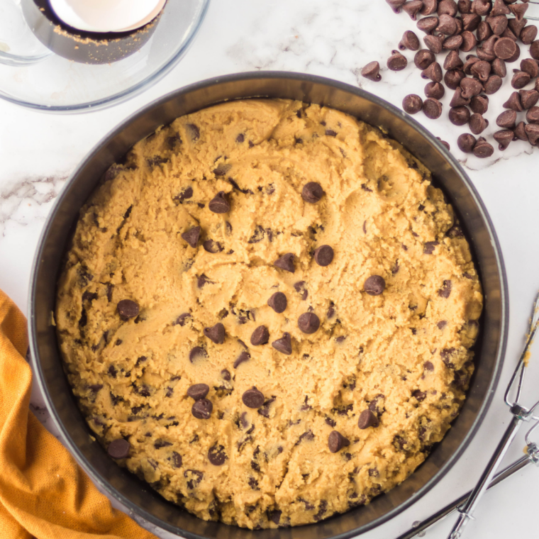 Chocolate chip cookie dough pressed into a round pan before air frying