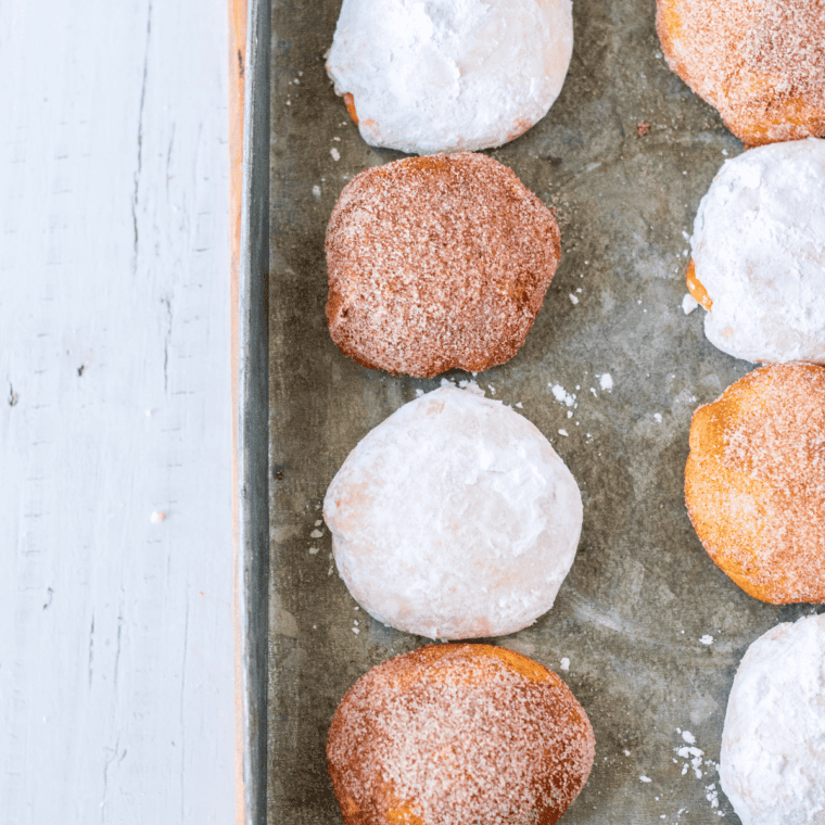 Air fryer churro donut holes rolled in cinnamon sugar on a plate