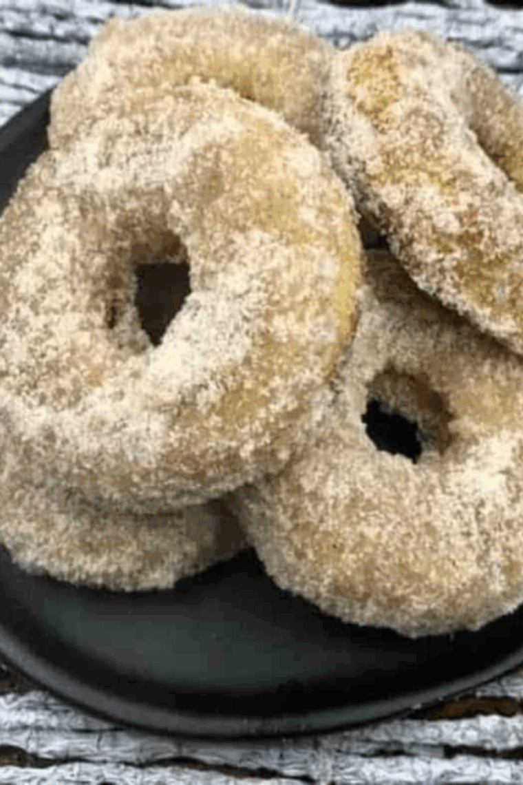 Freshly baked air fryer cinnamon sugar banana donuts, golden and fluffy, ready to serve.