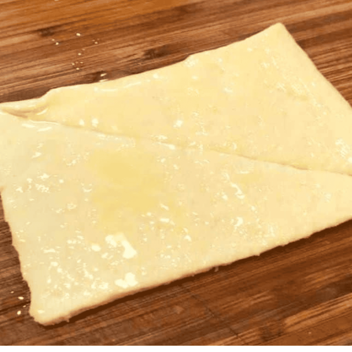 Brush dough with melted butter.