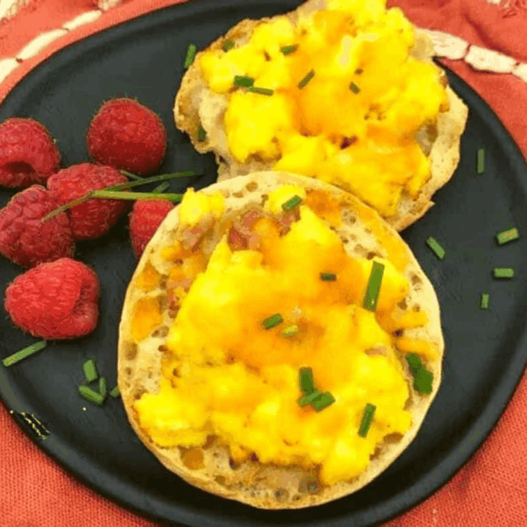 Air Fryer English Muffin Breakfast Pizza with melted cheese, egg, and savory toppings on a crispy muffin base.