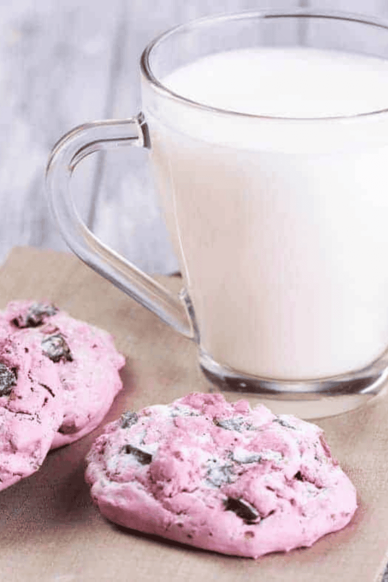 Freshly baked air fryer strawberry cake mix cookies stacked on a plate.