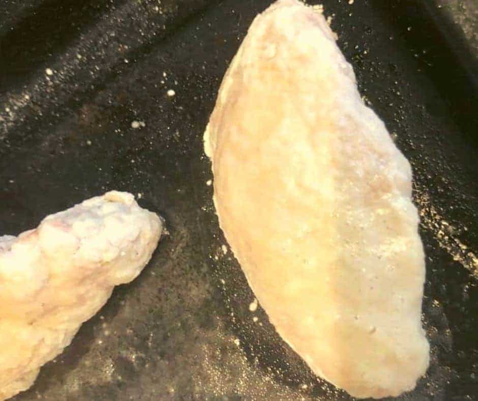 Placing seasoned chicken wings into the air fryer basket in a single layer.