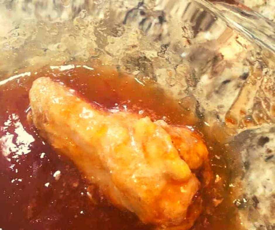 Brushing air-fried wings with additional red pepper jelly for a glossy coating.
