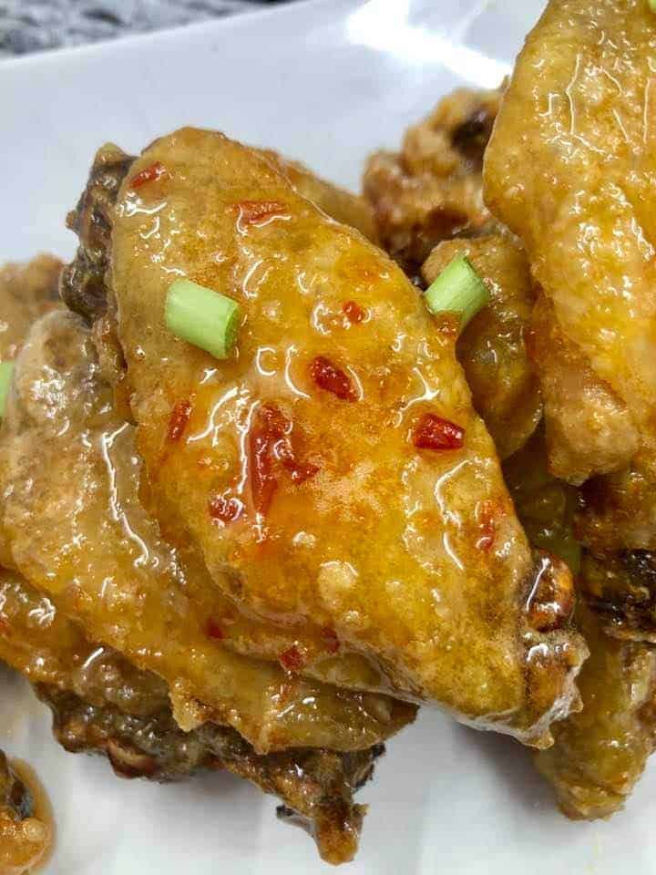Serving crispy red pepper jelly wings on a plate, ready to enjoy.