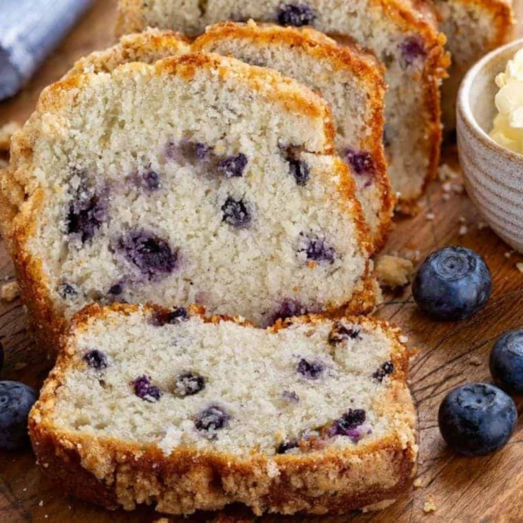 Stack of air fryer blueberry bread slices studded with fresh blueberries