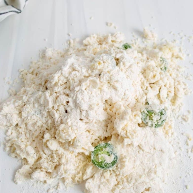 Greek yogurt and self-rising flour mixed into a shaggy bagel dough in a glass mixing bowl