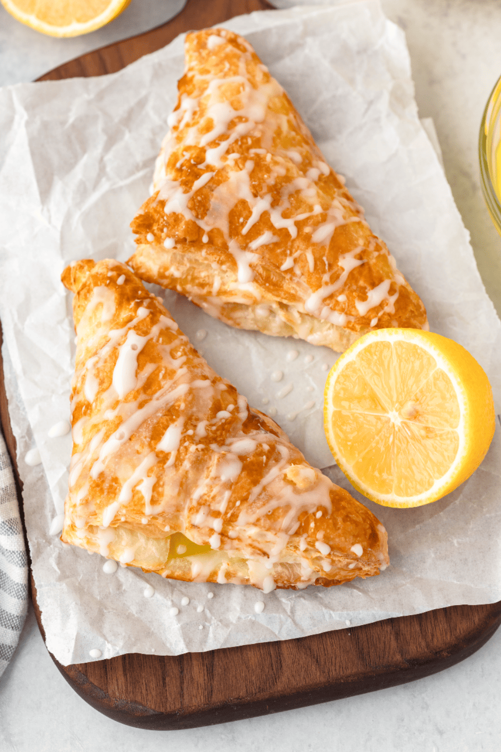 "Plate of golden-brown Air Fryer Lemon Turnovers drizzled with sweet glaze."