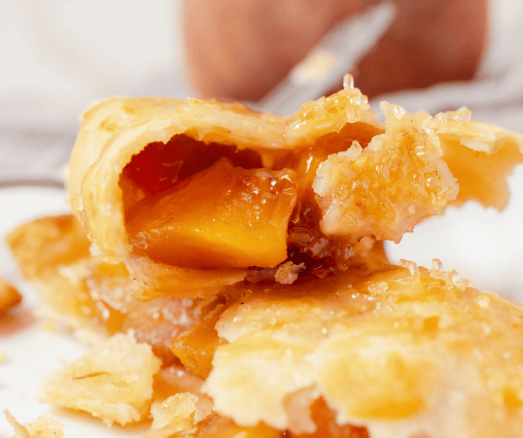 Fresh peaches peeled and diced into small cubes on a cutting board
for air fryer hand pies