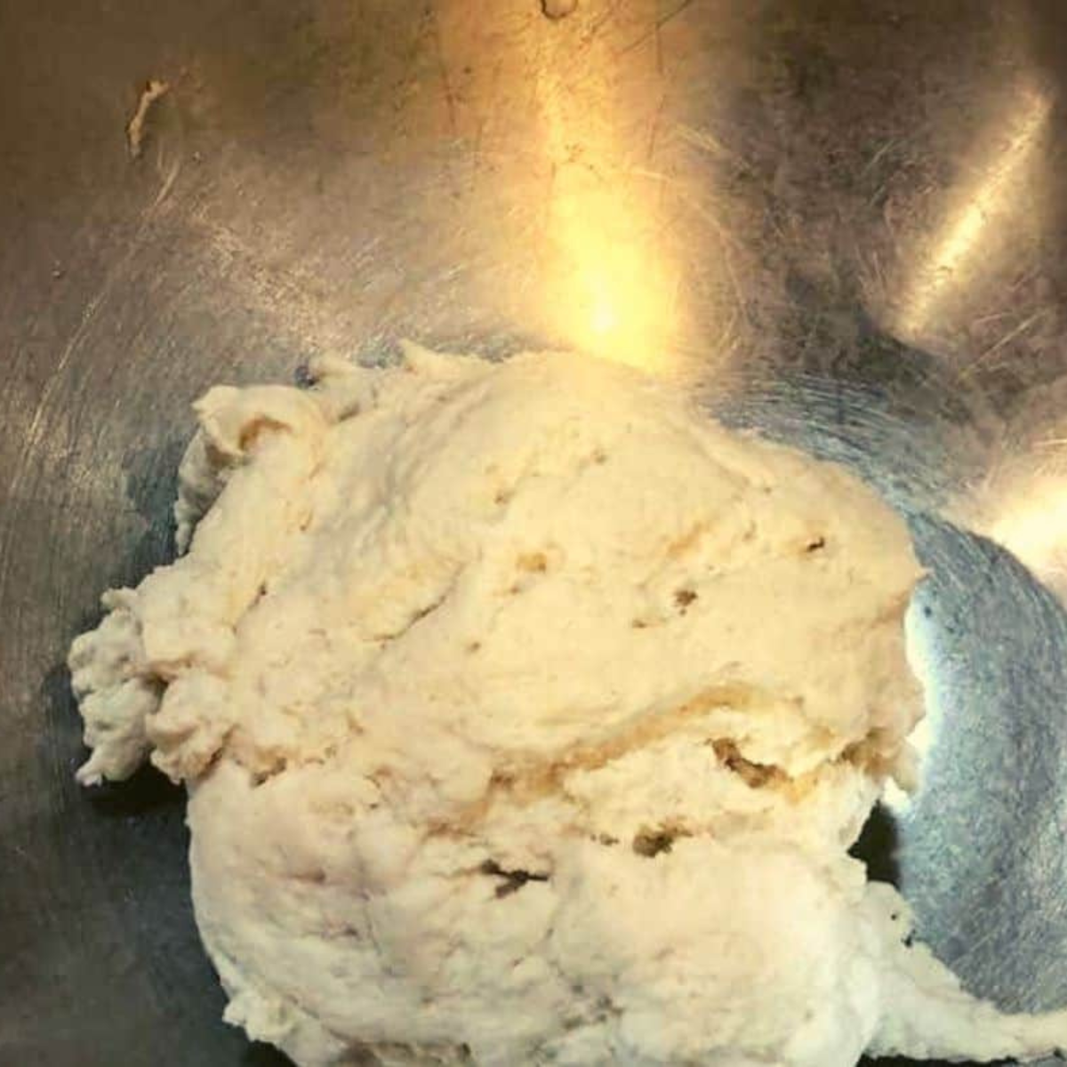 Mixing Dough for Poppy Bagels: A bowl with mixed ingredients for poppy bagel dough, including flour, yeast, water, and salt.