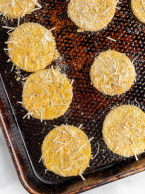 Crispy air fryer summer squash slices on a white plate garnished with fresh parsley