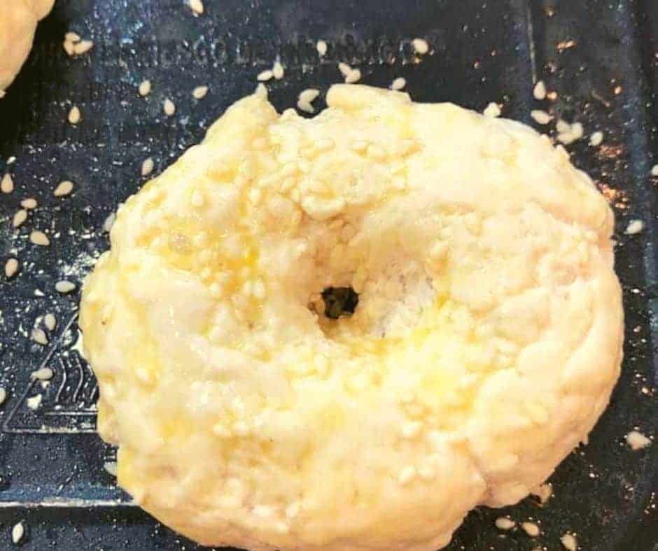 Shaping dough into bagel rings on a floured surface