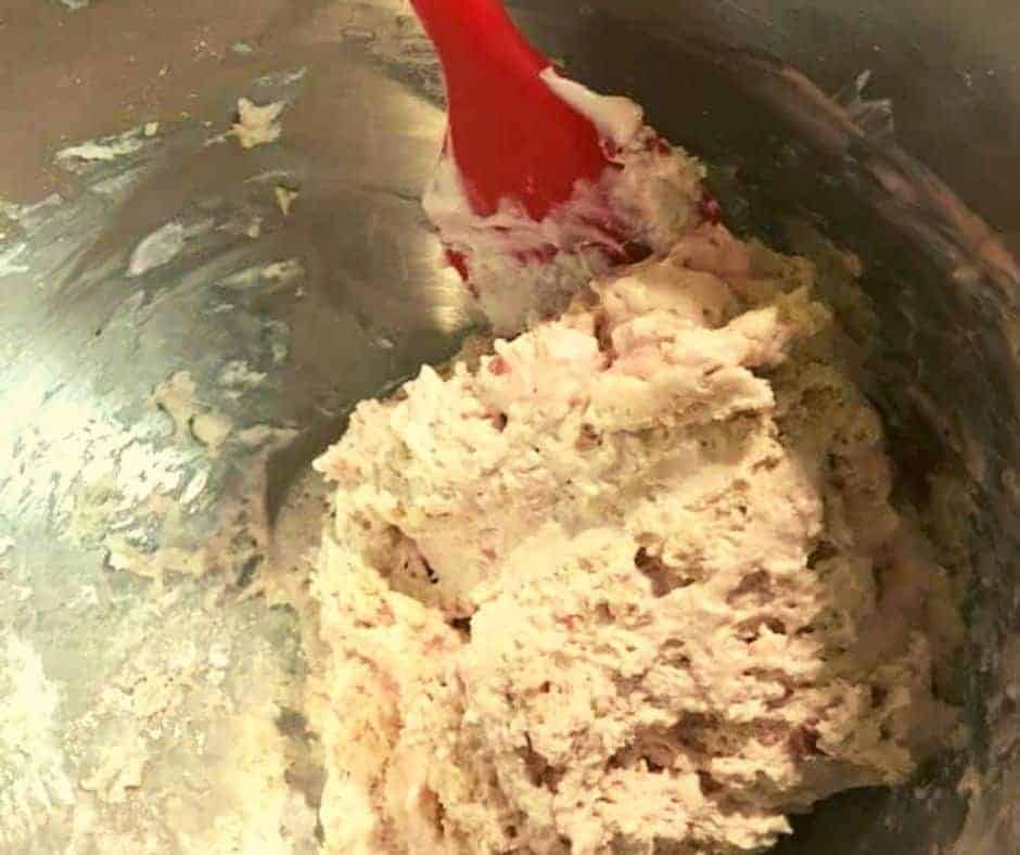 Mixing Ingredients: Combining strawberry Greek yogurt, self-rising flour, and other ingredients in a bowl.