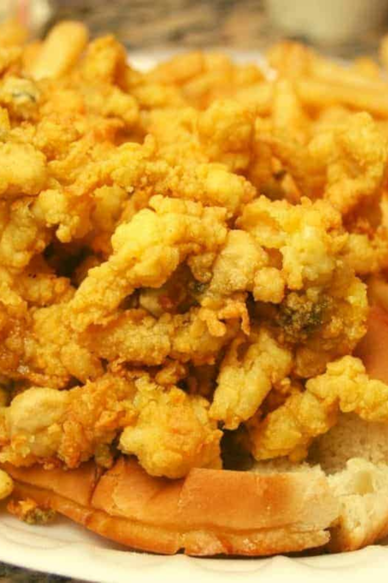 Plump air fried whole-belly clams on parchment paper