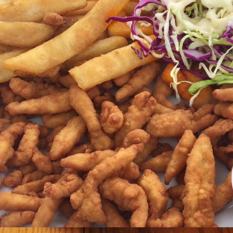 Overhead view of crispy frozen clam strips air fried and ready to serve