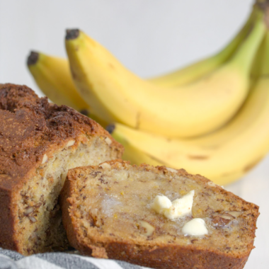 Moist air fryer banana nut bread sliced and served with chopped walnuts on top