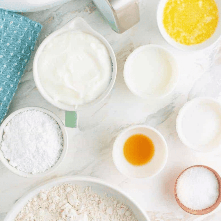 Ingredients for air fryer crumb cake including flour, butter, sugar, egg, sour cream, and cinnamon