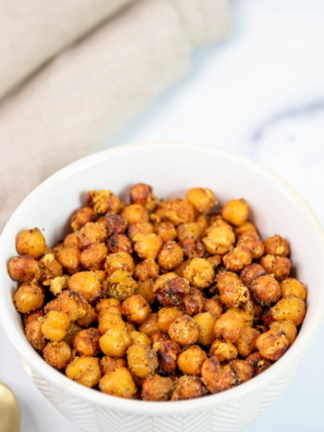 A bowl of crispy air fryer taco seasoned chickpeas dusted with chili powder and cumin
