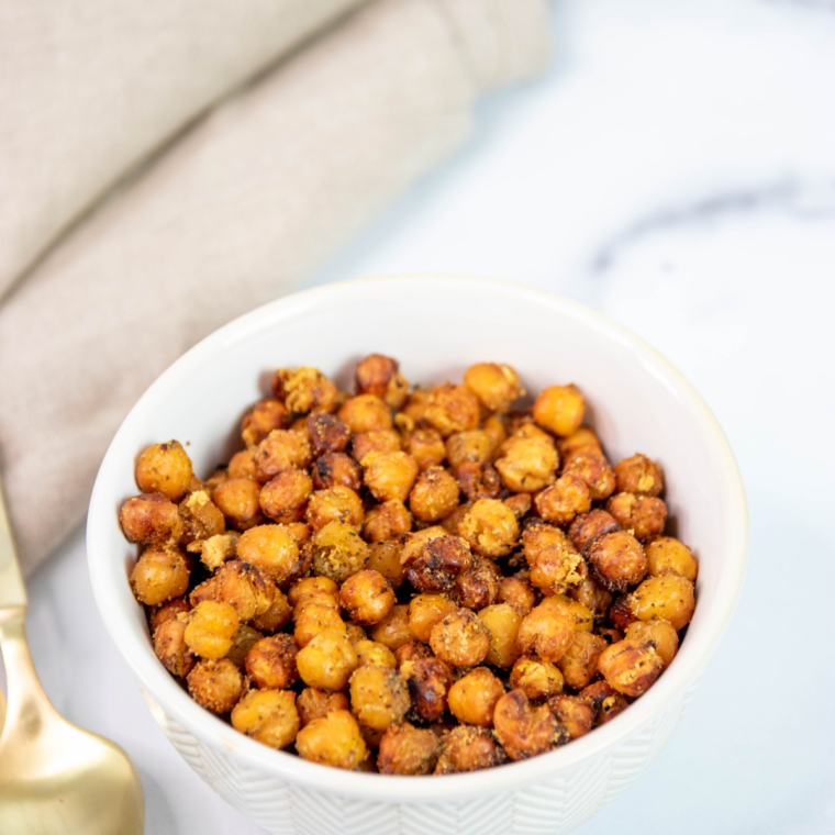 A bowl of crispy air fryer taco seasoned chickpeas dusted with chili powder and cumin.