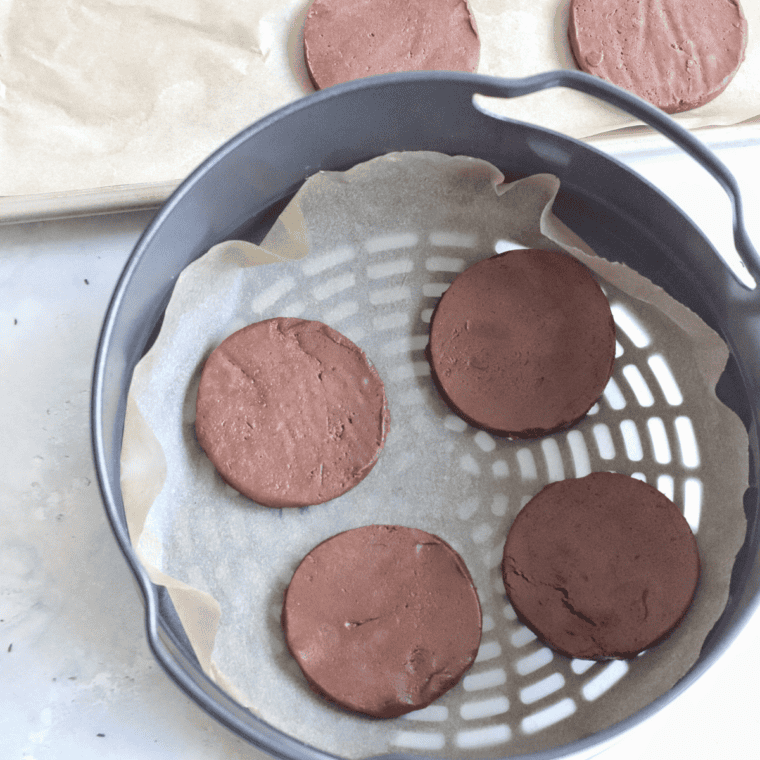 Air fryer with cookies cooking at 320°F, showing golden, soft-centered cookies.