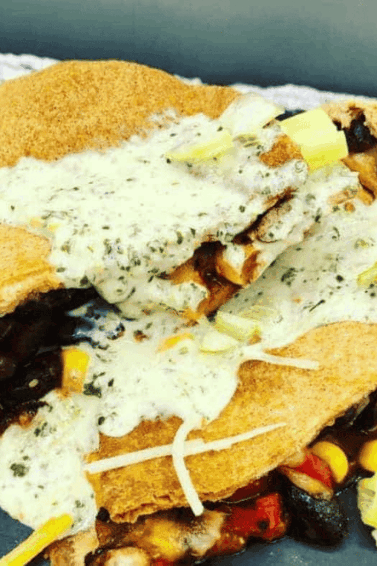 Golden air fryer black bean and corn quesadilla with melted cheese inside