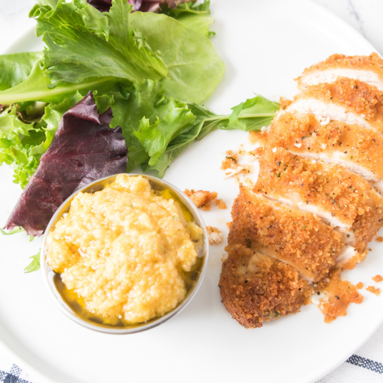 Crispy air fryer chicken costoletta cutlet topped with lemon cream sauce and parsley