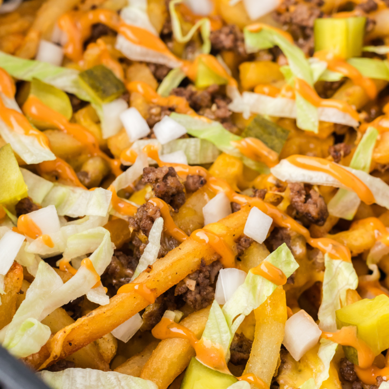 "Close-up of air fryer chili cheese fries with a side of dipping sauce."
