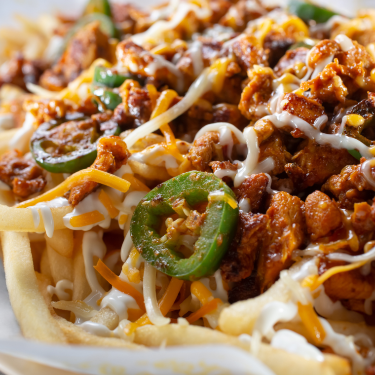 "Golden brown air fryer chili cheese fries topped with melted cheese and chili."