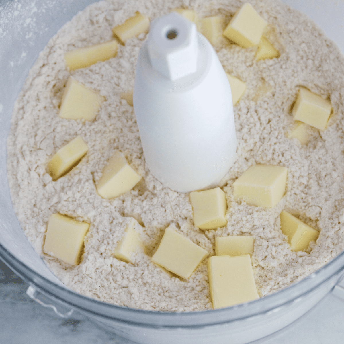 Heavy cream and egg added to the dry scone mixture in a food processor